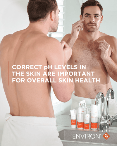 White and orange environ skincare product set on a bathroom counter.