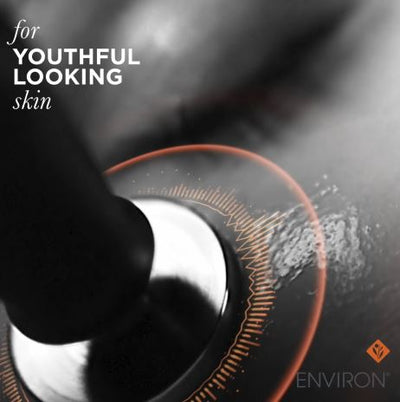 Black and silver facial device with orange accent ring for youthful looking skin