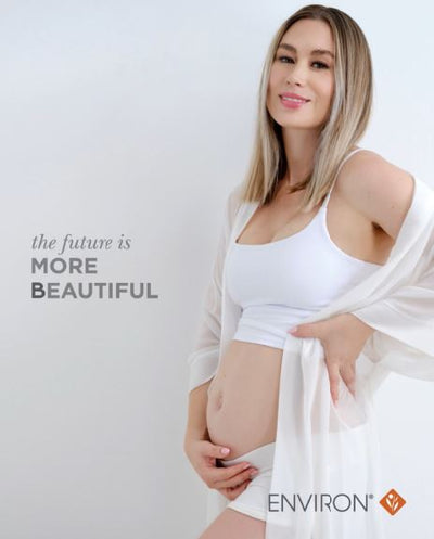 White maternity tank top with a scoop neckline and thin straps, worn by a pregnant woman.
