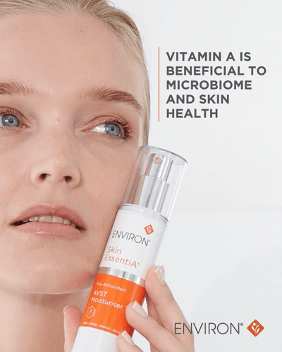 A sleek white and orange enviro skin essentia avst moisturiser bottle with a clear pump dispenser.