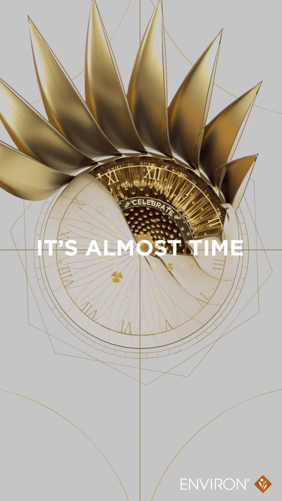 Golden, sunburst-inspired clock face with roman numerals and a central ’celebrate’ inscription.