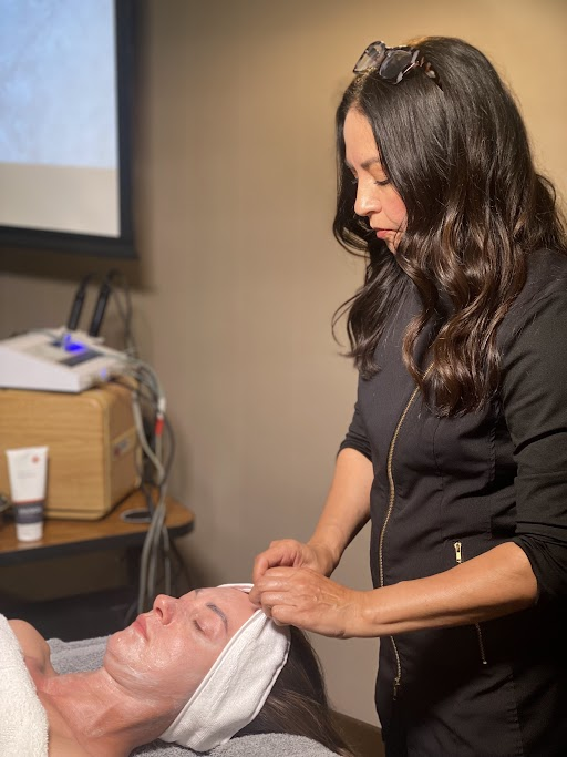 White fabric headband worn by a person receiving facial treatment