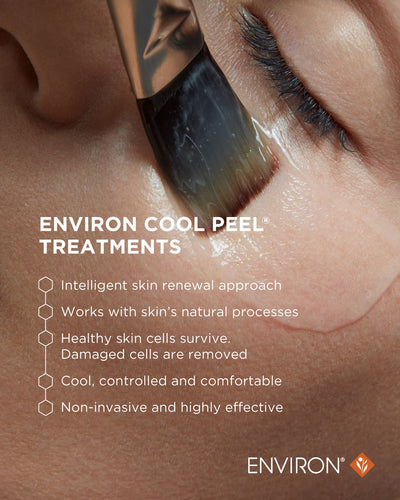 A sleek, metallic-bristled brush with a black handle is applying a clear gel to the skin.