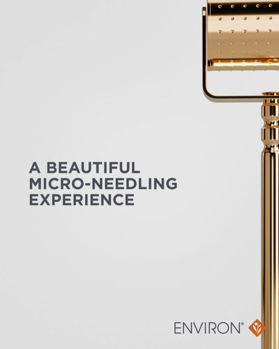 Gold-toned micro-needling device with a sleek, polished metallic finish and an array of fine needles arranged in a grid pattern.
