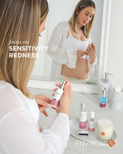 A sleek, transparent glass bottle with a silver pump and pink liquid inside.
