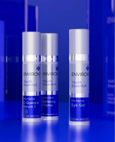 Three sleek silver and blue environ youth essentia skincare products, including a c-quence serum 1, antioxidant defence crème, and eye gel.