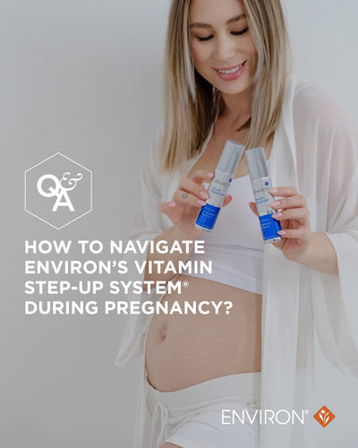 Two silver-topped, blue-labeled environ vitamin step-up system bottles held in a woman’s hands.