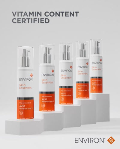 White and orange environ skin essentia avst moisturiser bottles with silver pump dispensers.
