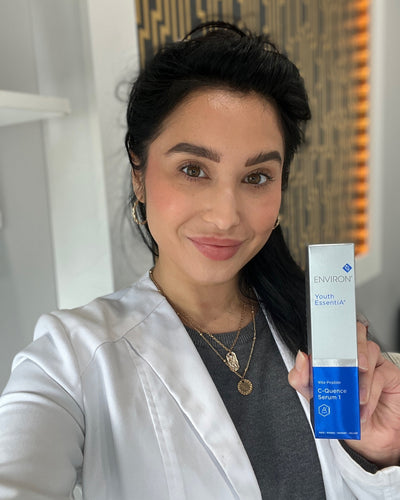 A sleek, rectangular bottle of environ youth essential c-quence serum 1 with a white and blue label.