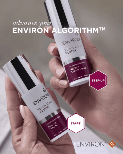 Two sleek, silver-topped white bottles of environ focus care youth+ retinol serum forte with maroon labels.