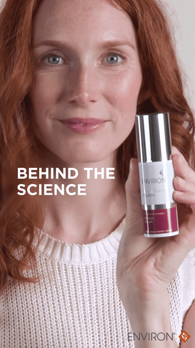 Silver and maroon environ skincare serum bottle with a sleek, cylindrical design.