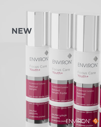 Three sleek silver-topped bottles of environ focus care youth+ retinol serum, each with a white label and deep magenta lower section.
