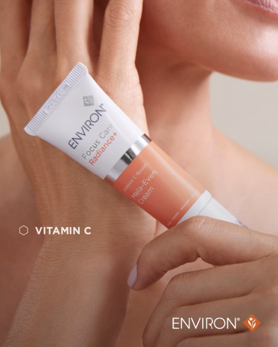 White and peach-colored tube of environ focus care radiance+ halo-eye cream