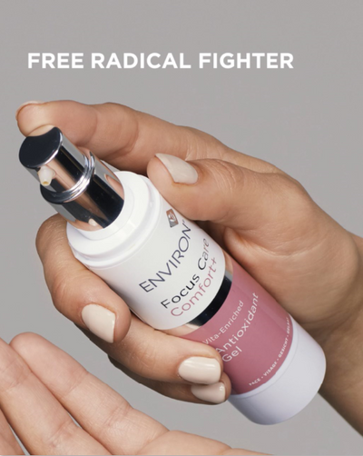 A white and pink environ focus comfort antioxidant gel bottle with a sleek silver pump dispenser.