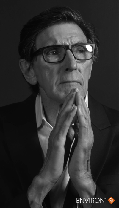 Black-rimmed rectangular glasses worn by a man.