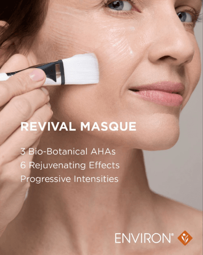 White brush with black handle applying a revival masque by environ.