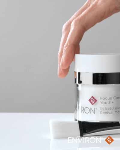 A sleek white jar with a silver metallic lid, featuring the environ brand and ’focus care youth+ revival mask’ label.