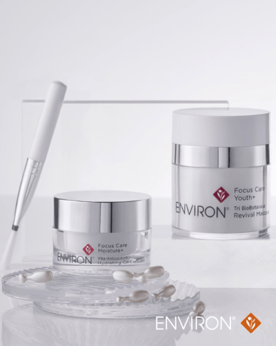 Silver-toned, sleek glass jar with a metallic lid and white label featuring the environ brand name.