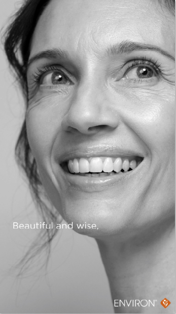 Black-and-white portrait of a smiling woman with expressive eyes and defined facial features.