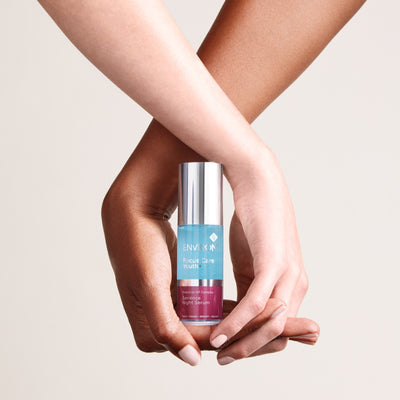 A sleek silver-topped glass bottle of environ focus care youth serene night serum with a gradient blue and pink label.