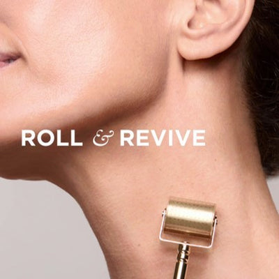 Gold-colored roller device with a sleek, cylindrical design and metallic finish.