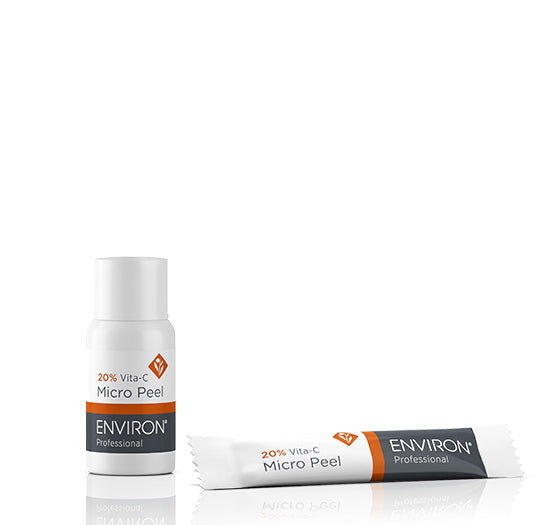 A bottle and sachet of Environ Professional 20% Vita-C Micro Peel rest on a clean, reflective white surface.