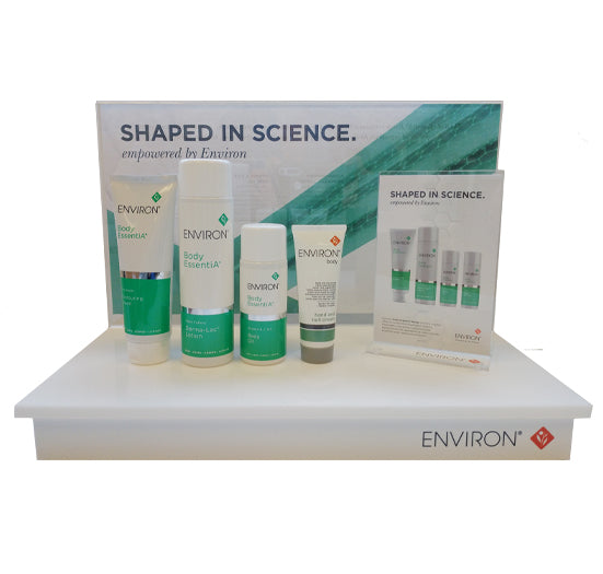 Environ Body EssentiA skincare products stand on a white retail display featuring "Shaped in Science" branding.