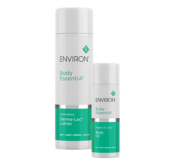 Environ Body EssentiA Derma-Lac Lotion and Vitamin A, C &amp; E Body Oil stand together in elegant white and teal packaging.