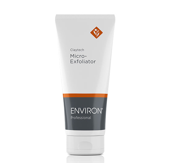 A white tube of Environ Professional Claytech Micro-Exfoliator showcases its sleek grey and orange branding against a clean, white background.