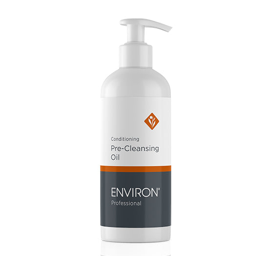 A white pump bottle of Environ Professional Conditioning Pre-Cleansing Oil showcases its minimalist label with orange and grey accents.