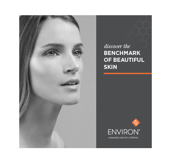 An Environ skincare advertisement features a black and white portrait of a woman with clear skin alongside the slogan "discover the benchmark of beautiful skin."