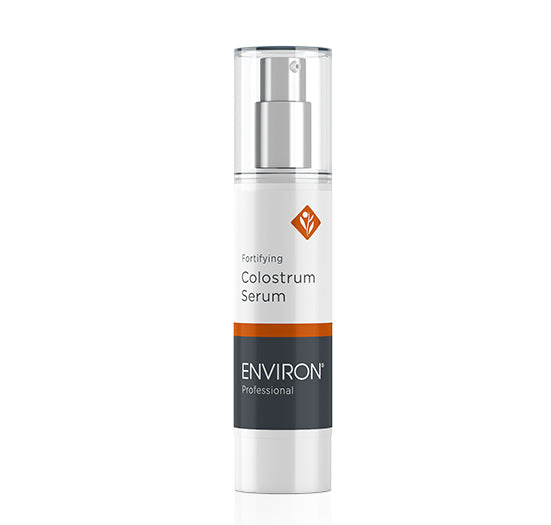 A sleek white airless pump bottle showcases Environ Professional Fortifying Colostrum Serum with a silver dispenser and clear lid.