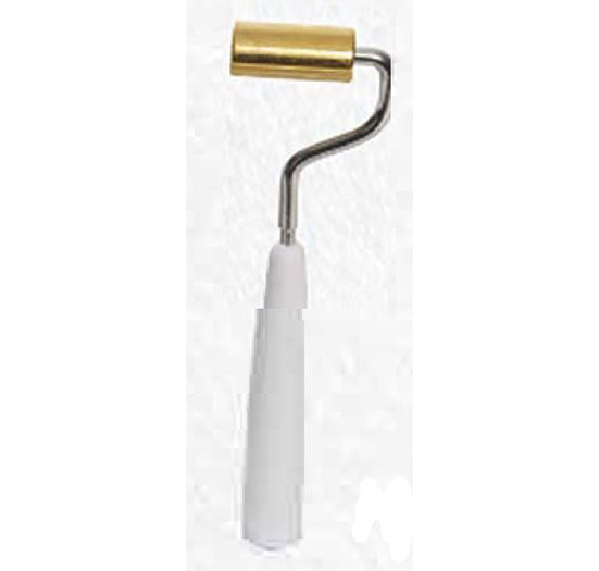 A professional brass seam roller with a white handle and metal frame provides precision for smoothing wallpaper and leather seams.