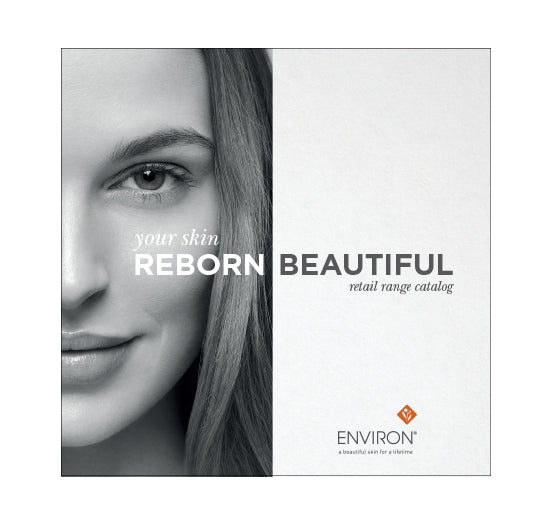 A woman with clear, healthy skin smiles softly on the cover of an Environ skincare retail range catalog featuring the text "your skin reborn beautiful."