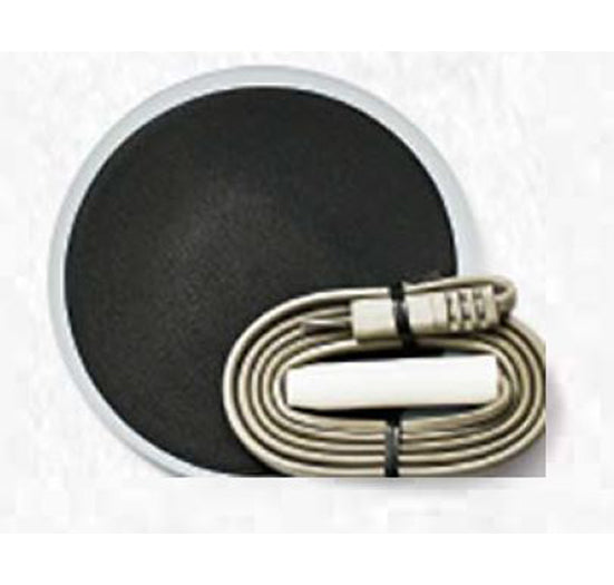 A circular black conductive electrode pad sits beside a coiled grey lead wire used for medical therapy.