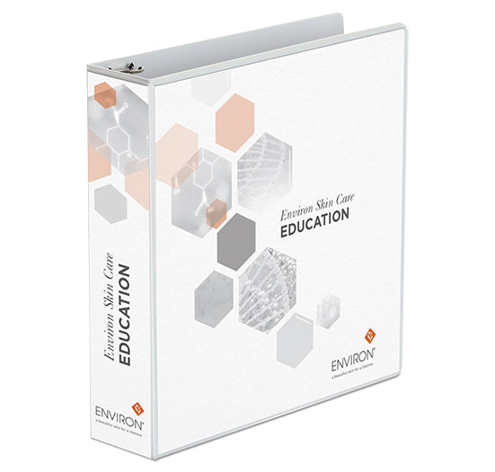 A white Environ Skin Care Education three-ring binder displays professional branding and geometric hexagon graphics for skincare training.