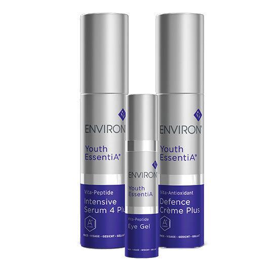 Three Environ Youth EssentiA skincare products, including the Intensive Serum 4 Plus, Eye Gel, and Defence Crème Plus, stand arranged against a white background.